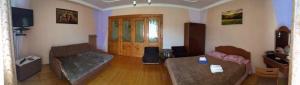 a living room with two couches and a table at Usadba Bilya Richky in Skole
