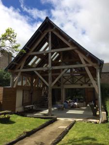 a large wooden pavilion in a yard at CHAMBRE ROMANTIQUE CHEZ L'HABITANT à LAMBALLE in Lamballe