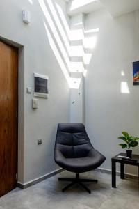 a black chair in a room with a ceiling at Old Town Boutique Apart Studio's - Rethymno in Rethymno Town