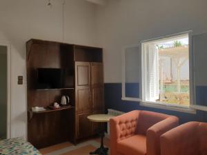 a living room with a couch and a chair and a window at Maison Duffal in Azrou