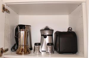 a coffee maker and a blender on a shelf at Aloe Friendly Holiday Home in Playa del Ingles