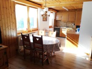 a kitchen with a table and chairs in a room at Chalet Hedy Ferienwohnung in Grächen