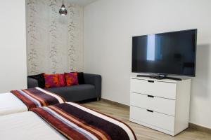 a living room with a television and a couch at La Vega de Mary in Arrecife