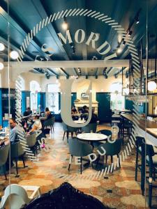 a restaurant with tables and people sitting at tables at Hotel Clarendon in Quebec City