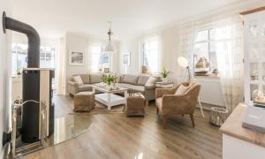 a living room with a couch and a table at Sanddollar in Zingst
