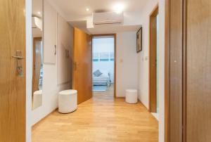 a hallway with two white stools in a room at Apartment Luna in Omiš +19 photos