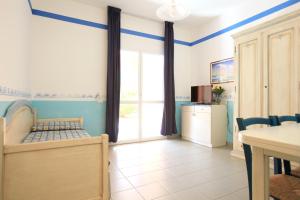 a room with a bedroom with a bed and a table at TH Ortano - Ortano Mare Residence in Rio Marina