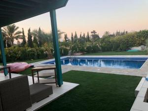 a view of a swimming pool from the patio of a house at Oasi Rejuve Poseidon in Meneou +4 photos