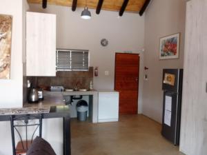 a kitchen with a refrigerator and a counter top at Marloth Wild Fig Studio in Marloth Park