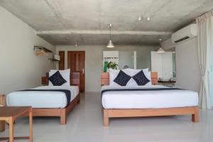 Postel nebo postele na pokoji v ubytování Wabi Sabi Boutique Hotel - SHA Extra Plus