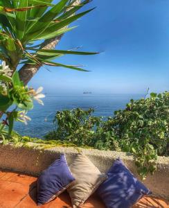 two pillows sitting on a ledge overlooking the ocean at Casa delle Galee in Scilla