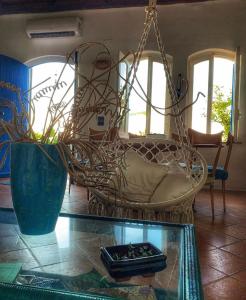 a room with a swinging chair and a glass table at Casa delle Galee in Scilla