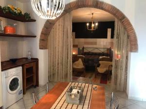 a kitchen and living room with a washer and dryer at Happy Flat in Riparbella