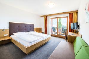 Postel nebo postele na pokoji v ubytování Hotel-Garni Ehrenfels