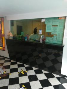 a man sitting at a counter in a restaurant at Hotel Dharma in Mexico City