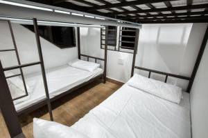 Ein Bett oder Betten in einem Zimmer der Unterkunft 5.T Hostel