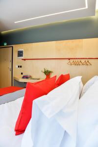 a bedroom with two beds with red pillows at CentraL44 OMG Casual Suite in Athens