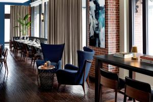 a dining room with a long table and chairs at The Boxer in Boston