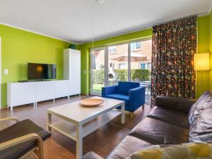 a living room with a couch and a table at Delightful Holiday Home in Zierow near Seabeach in Zierow