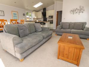 a living room with a couch and a table at Mereside in Carnforth