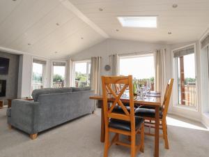 a living room with a couch and a table and chairs at Mereside in Carnforth