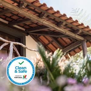 a sign that says clean and safe next to a building at Casas de Campo do Pomar B&B - Self Check-in in Santana