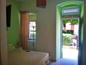 a bedroom with a bed and a door to a patio at DOWNTOWN Mavili's Studio in Corfu