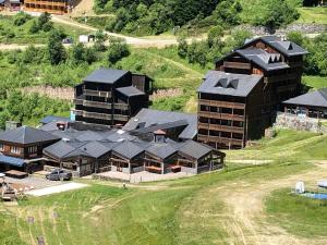 an aerial view of a large building on a hill at Appartement 4 personnes aux pieds des pistes, Ariège in Ustou