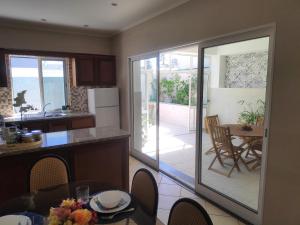 a kitchen with a sliding glass door leading to a patio at House Fifteen in Horta