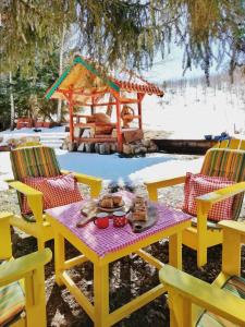 a picnic table and chairs with a gazebo at Sunny Hill kuća za odmor na Zlataru in Vukovina