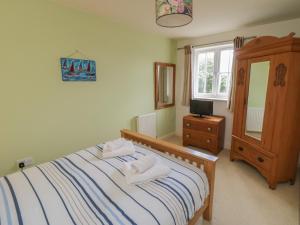 a bedroom with a bed with two towels on it at Driftwood in Filey