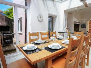 a dining room with a table and chairs and a fireplace at Wedgwood in Salcombe
