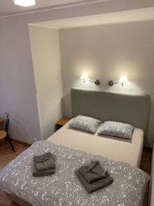 two beds in a room with a white bedspread at Pensjonat Złote Piaski i Restauracja Malibu in Jurata
