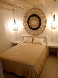 a bedroom with a bed with two lights and a mirror at Simousea in Kithnos