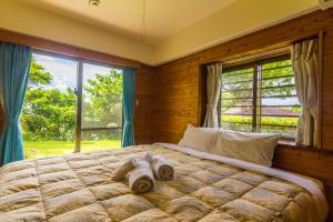 מיטה או מיטות בחדר ב-Ishigaki Sunset Cove