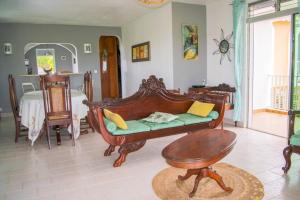 a living room with a couch and a table at Le Domaine de Boisvin in Sainte-Anne