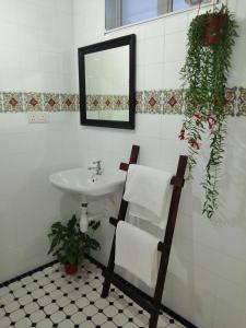 a bathroom with a sink and a mirror at Great Shanghai Guesthouse in George Town