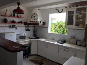a kitchen with a sink and a window at Maison Canne à Sucre in Grande Anse