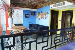 a balcony with a table and a couch at Aspira D'Andora Sukhumvit 16 - Asoke in Bangkok