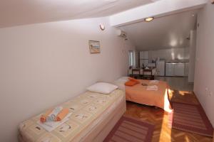 a bedroom with two beds in a room at Apartmani Damir Livajić in Omiš