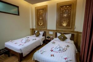 A bed or beds in a room at UCT Taunggyi Hotel