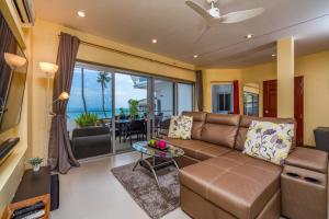 a living room with a couch and a table at Dreambeach 2-villas in Panwa Beach