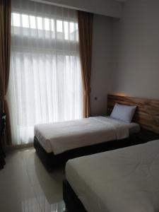 سرير أو أسرّة في غرفة في Antika Hotel