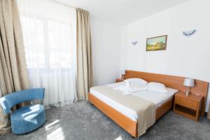 Un pat sau paturi într-o cameră la Hotel Hera