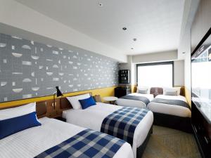Кровать или кровати в номере DEL style Osaka Shin Umeda by Daiwa Roynet Hotel