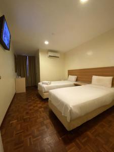 En eller flere senge i et værelse på SCC Hotel