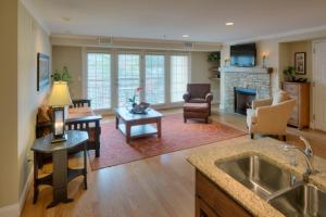 a kitchen and living room with a fireplace at The Residences at Biltmore - Asheville in Asheville