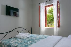 Postel nebo postele na pokoji v ubytování Pavlakis Lemon-Tree House