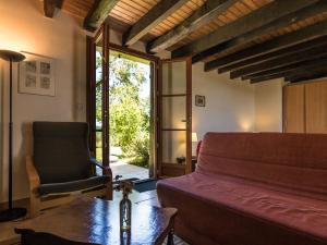 a bedroom with a bed and a chair and a table at Welcoming cottage in Savignac L drier with garden in Savignac-Lédrier