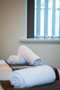 a person laying on a bed with a pillow at Hospitality Esperance, SureStay by Best Western in Esperance